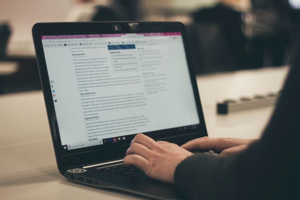 someone using a laptop, hands showing