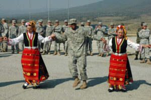 U.S. Army Soldier dancing with traditional Bulgarian dancers