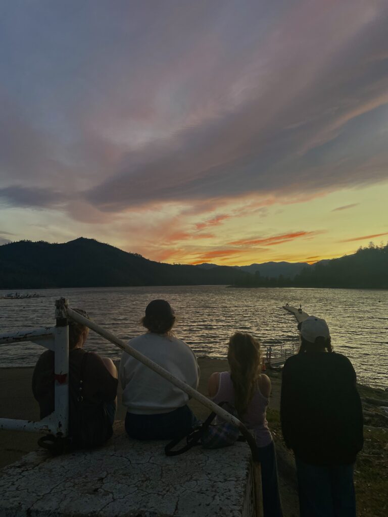 Photo of friends watching the sunset together