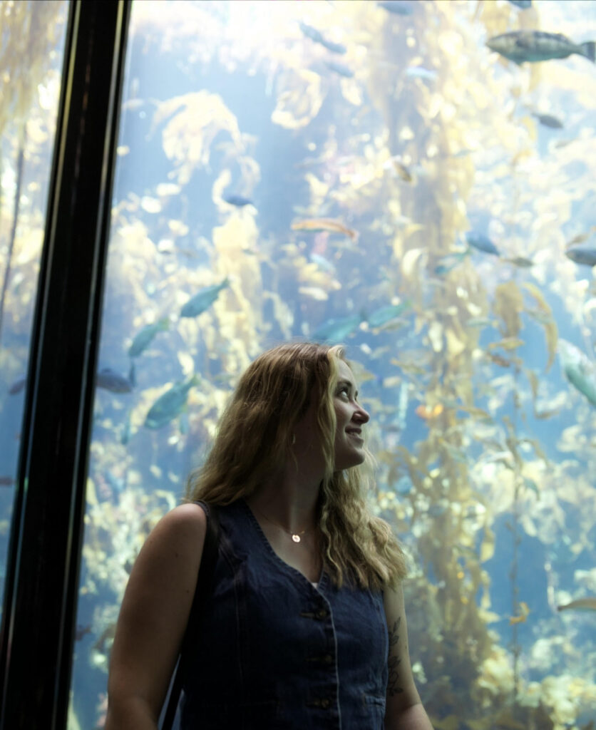 Photo of author in an aquarium looking at fish